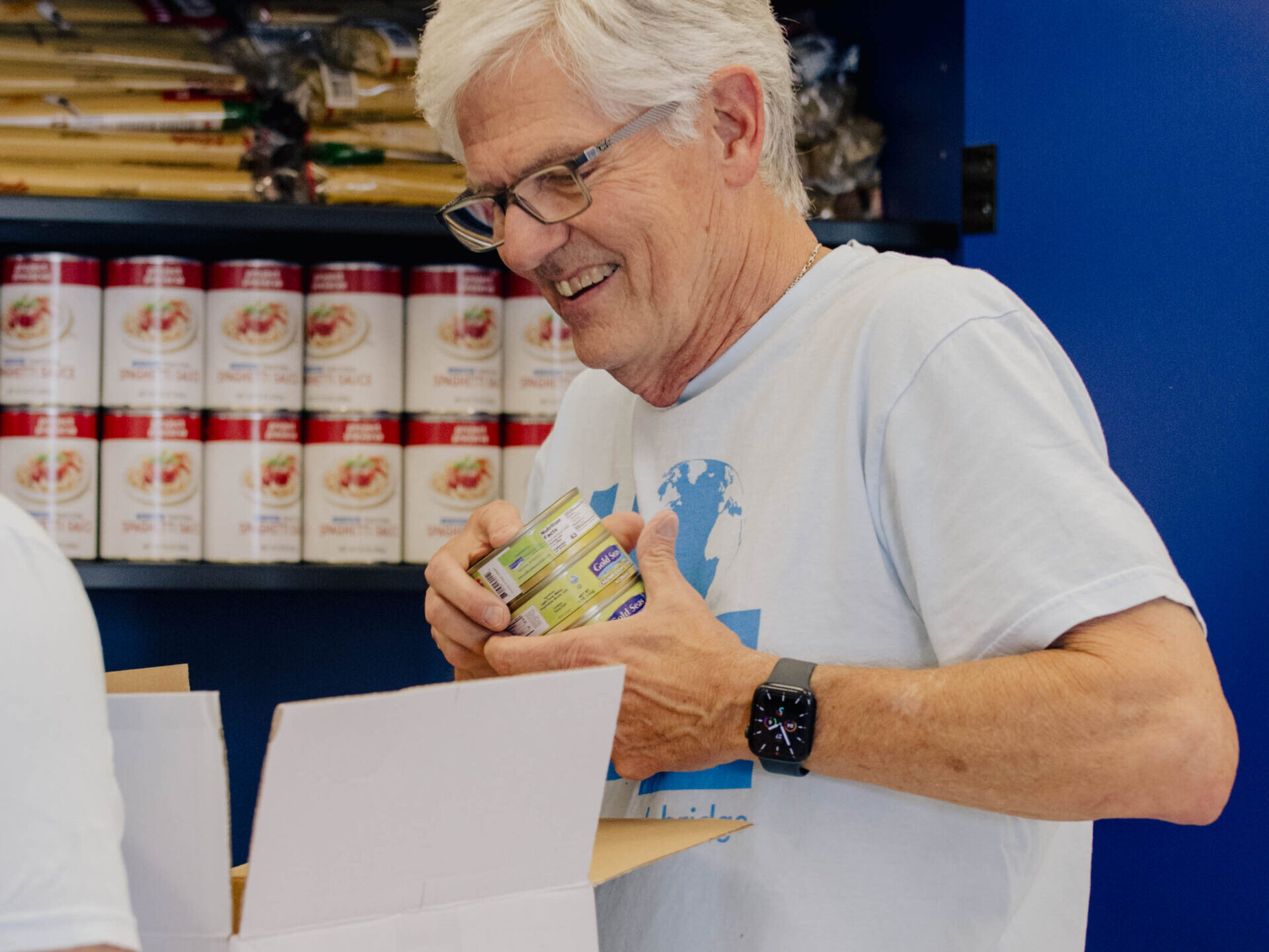 man putting food into box
