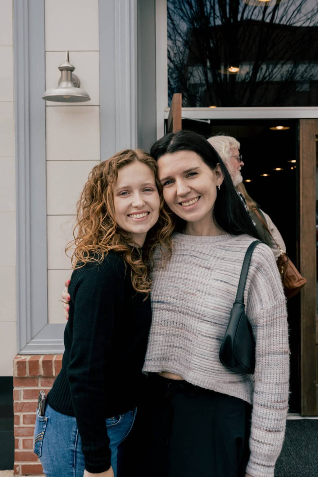 two women posing together smiling