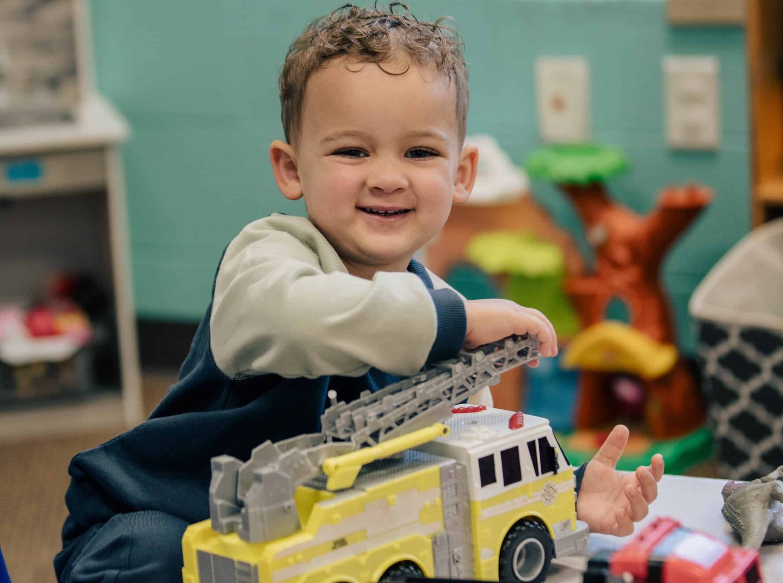 boy playing with toy truck