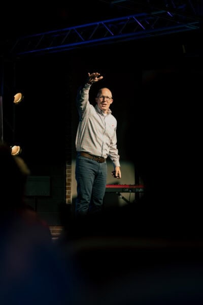 Matt Evans preaching during Easter 2025 male speaking on a church stage